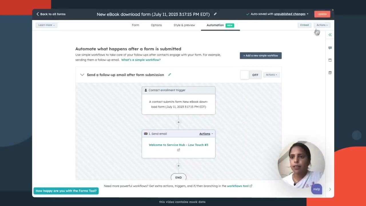Presenter gesturing with overlay text: 'Click the Link in the Description'