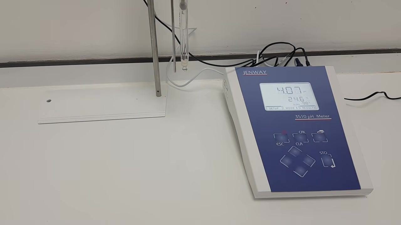 Jenway 3510 pH meter on a clean lab bench; the pH probe is suspended in a holder, ready for storage. The meter display reads 4.07 pH, 24.6°C, with no sample beaker present, indicating the probe is ready for capping and storage