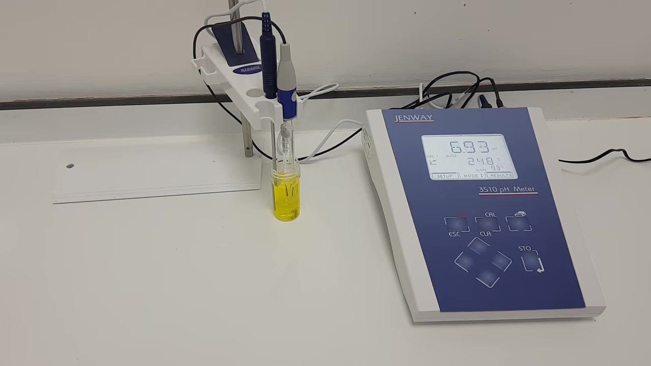 pH meter and probes in the buffer solution, waiting for the reading to stabilize