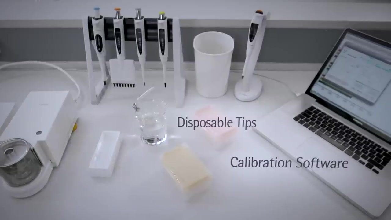 A laboratory bench setup with a balance, distilled water in a beaker, disposable pipette tips in boxes, a pipette stand with multiple pipettes, a waste container, and a laptop running calibration software. Each item is labeled: Balance, Distilled Water, Disposable Tips, Calibration Software.