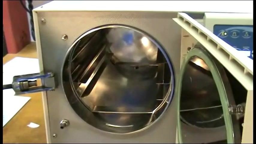 A hand inside the chamber confirming all Chamber Brite powder is emptied along the bottom.