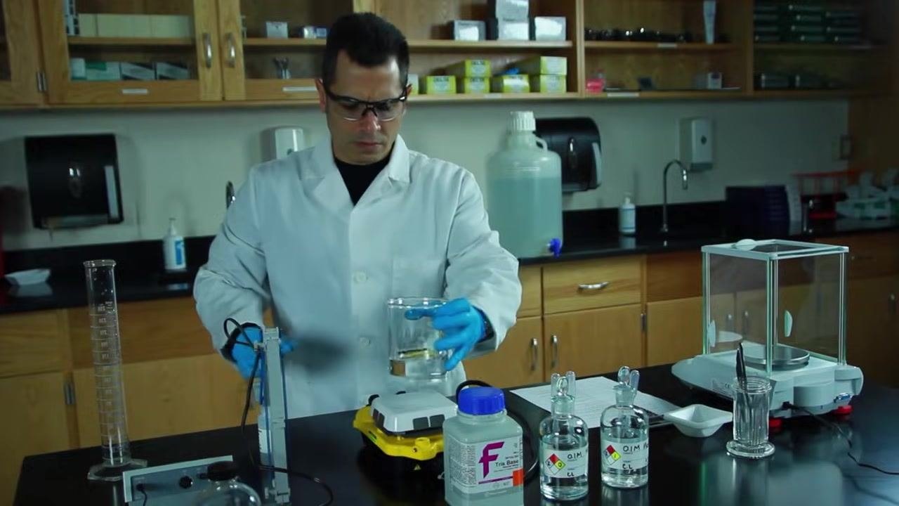Placing a beaker containing water and a stir bar onto a yellow stir plate