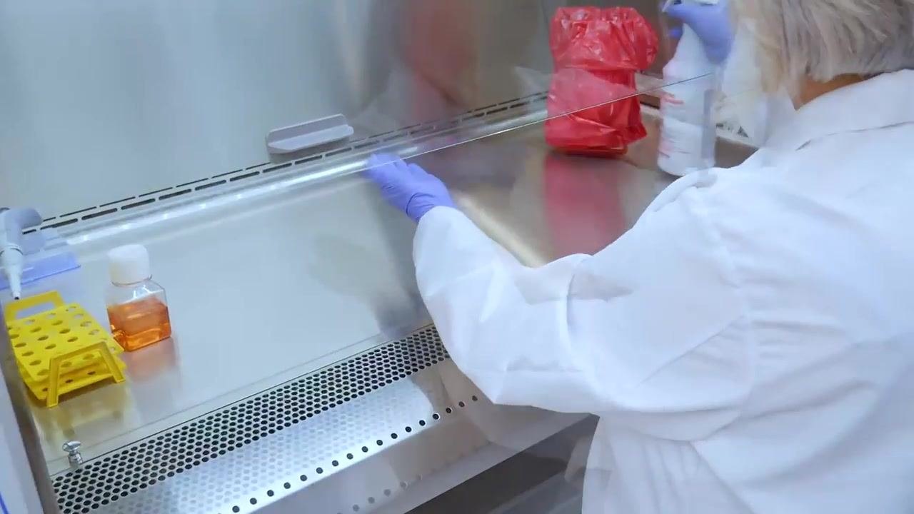 The worker keeps a bottle closed while handling a pipette, with only one item open at a time.