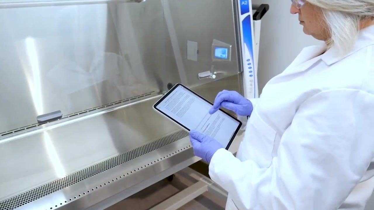 A Class II biosafety cabinet installed in a laboratory corner with clear space around it and no obstructions.