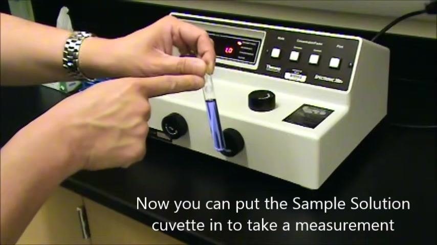 Hand aligning a sample solution cuvette with the sample compartment