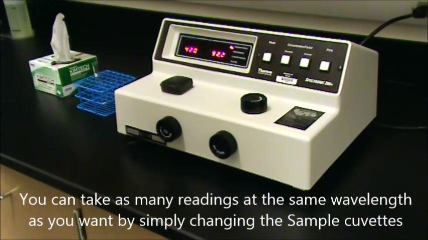 Spectrophotometer with a sample cuvette inserted, display showing 420 nm and 92.2