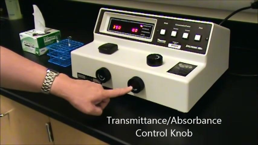 Spectrophotometer on a lab bench with an on-screen introduction to preparing cuvettes and solutions