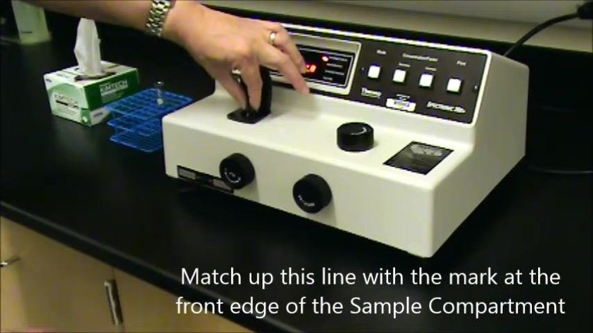 Spectrophotometer with the sample compartment open, display showing 420 nm and 0.0