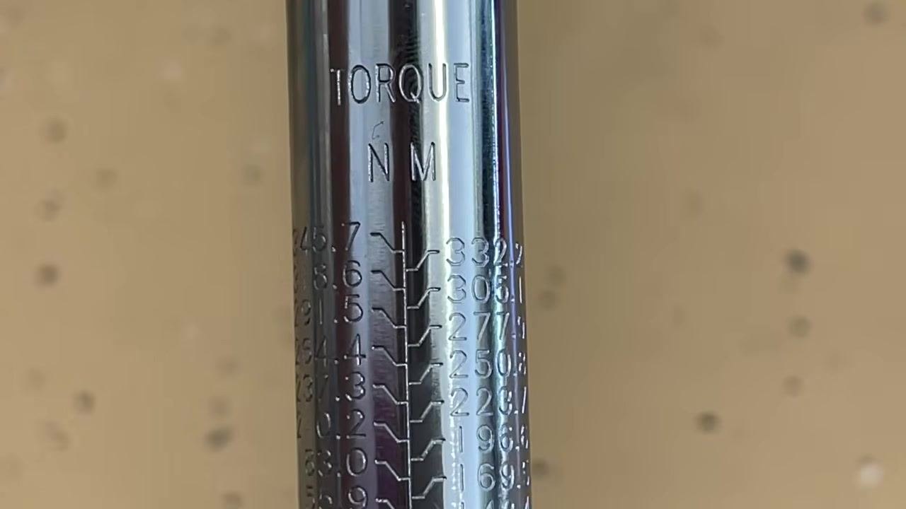 Close-up of the torque wrench shaft showing the Newton-meter (Nm) scale, with values from 74.6 to 345.7 Nm.