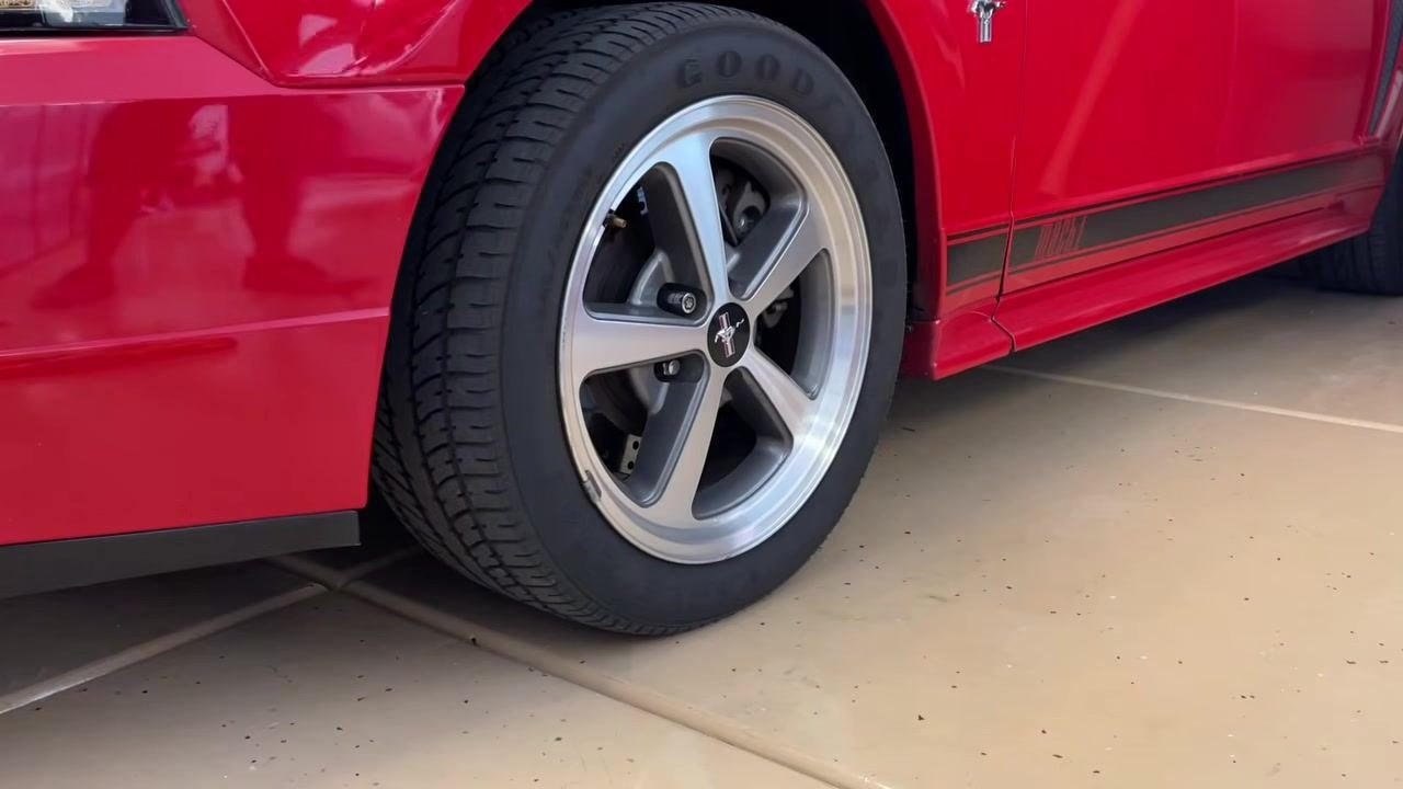 Red Ford Mustang wheel, illustrating the context for checking and applying the correct torque specification.