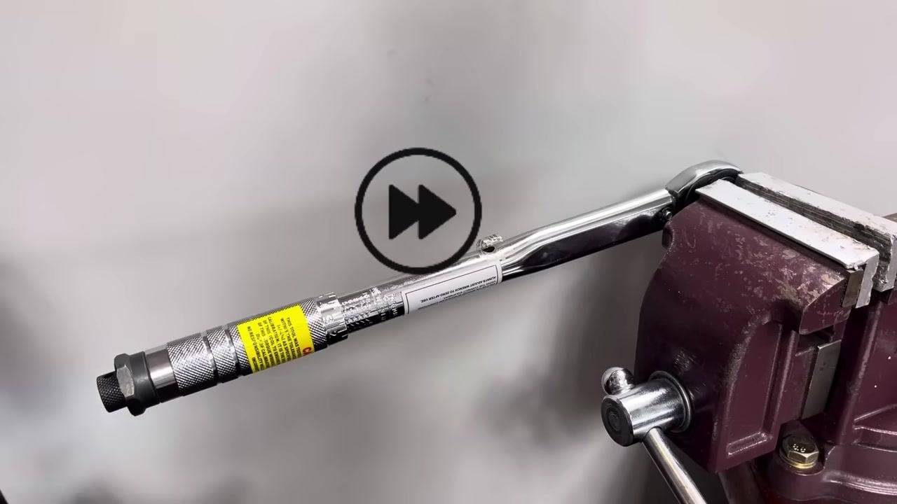 The torque wrench remains in the vise during repeated testing of the click point.