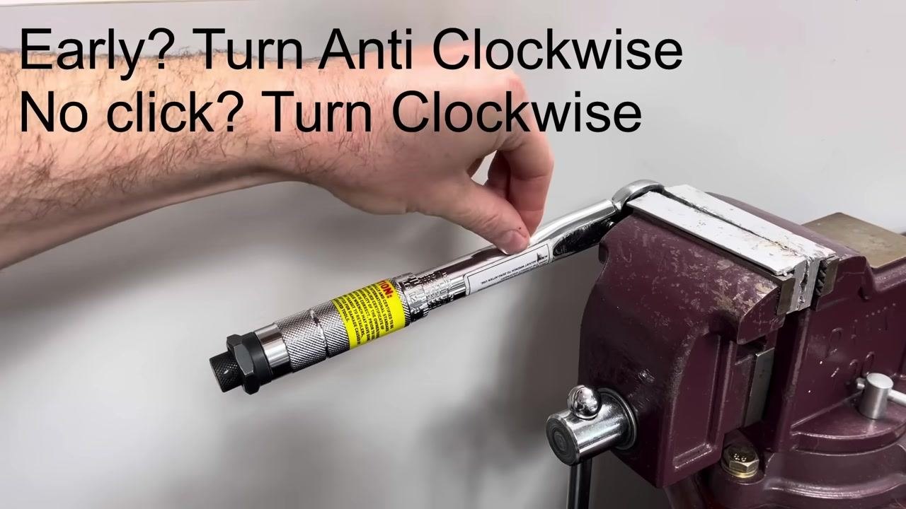 The torque wrench is clamped in the vice, with the rope being attached to the handle at the measured point.