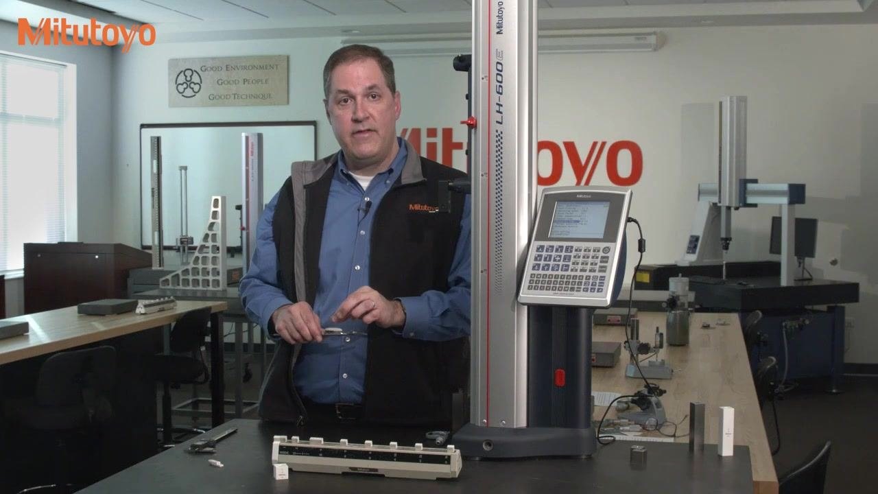 An explanation of gear wear in dial calipers, with a dial caliper held in a metrology lab alongside Mitutoyo equipment