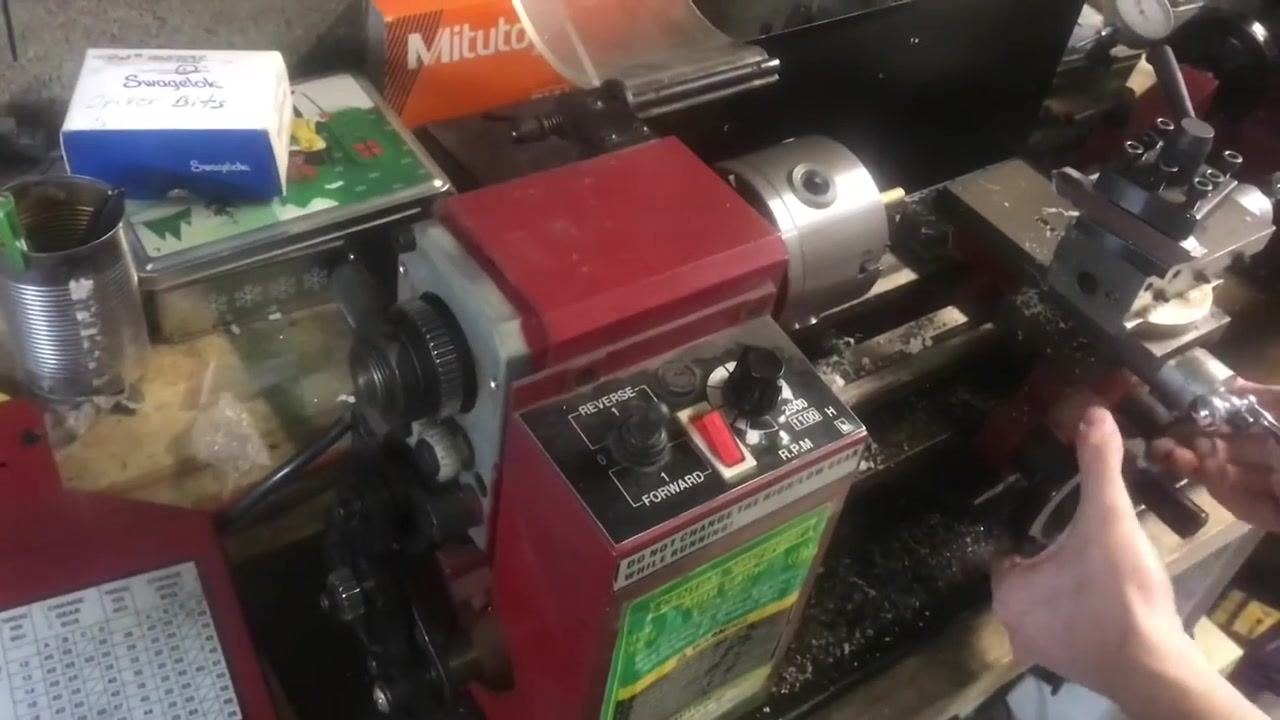 Hands holding the reversing lever and securing bolts to confirm the gear arrangement and direction.