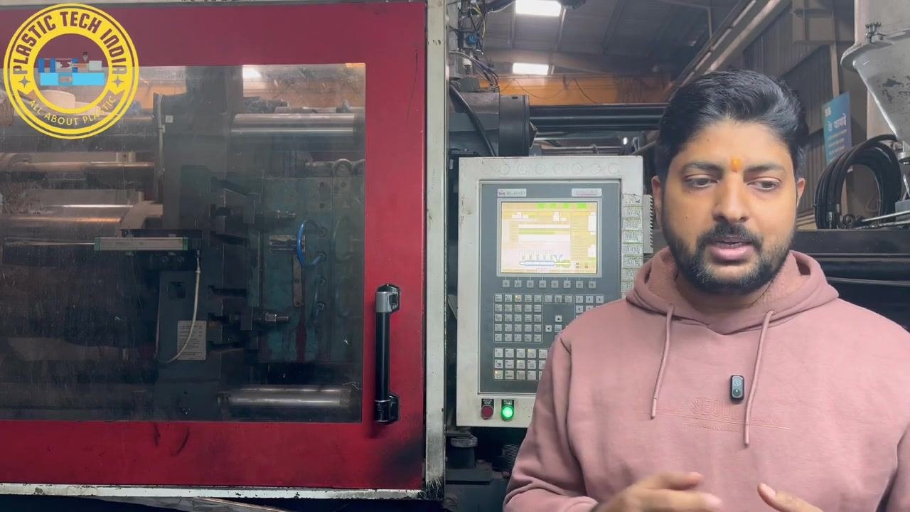 Presenter preparing to run the machine and begin systematic checks, standing in front of the machine and control panel.