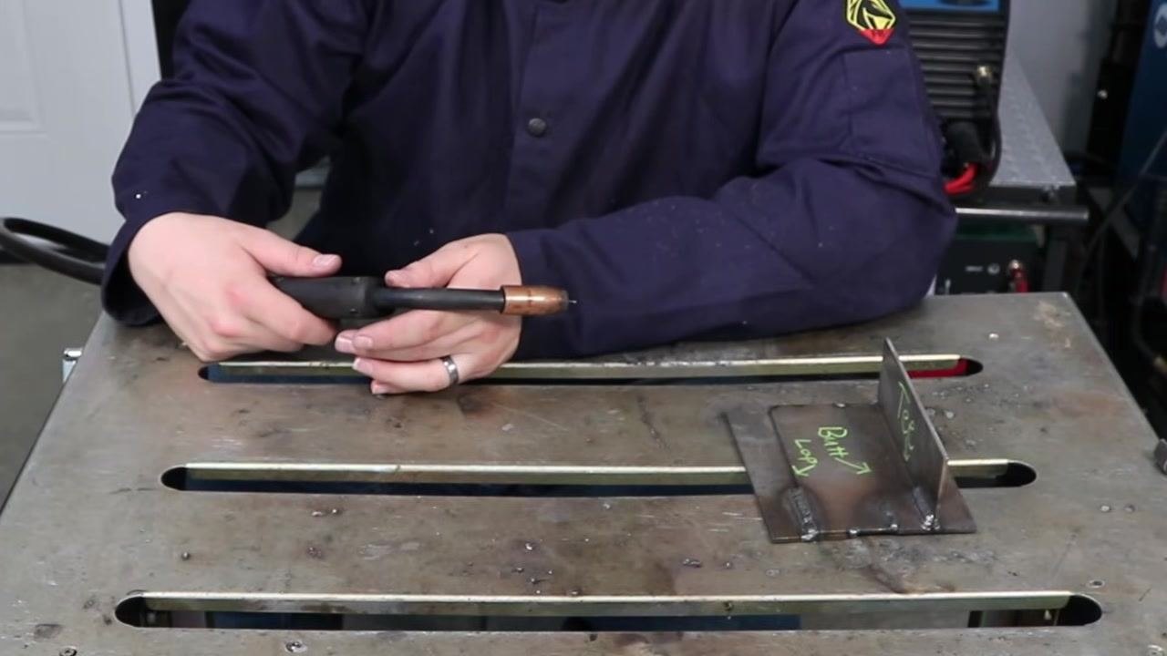 Welding arc with visible blue and yellow light, demonstrating a weaving technique during welding