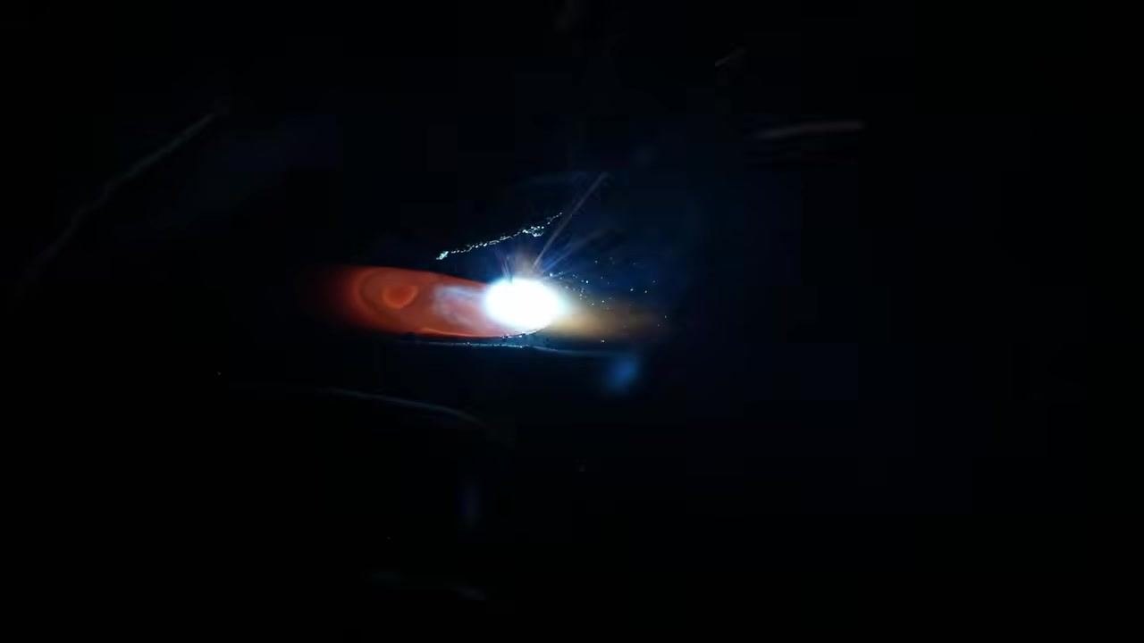 Welding arc with visible sparks, emphasizing the importance of staying centered on the joint during welding