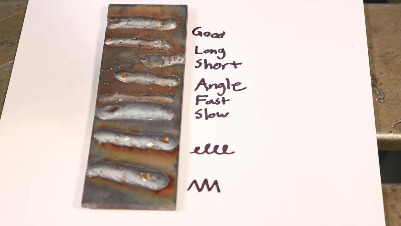 Close-up of a weld bead plate, highlighting the effects of arc length and spatter on weld quality