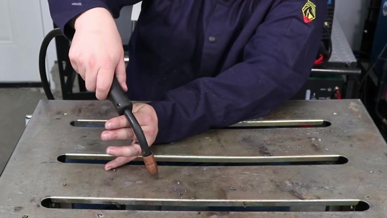 Welder starting to weld, maintaining proper stick out and using their hand for support along the joint