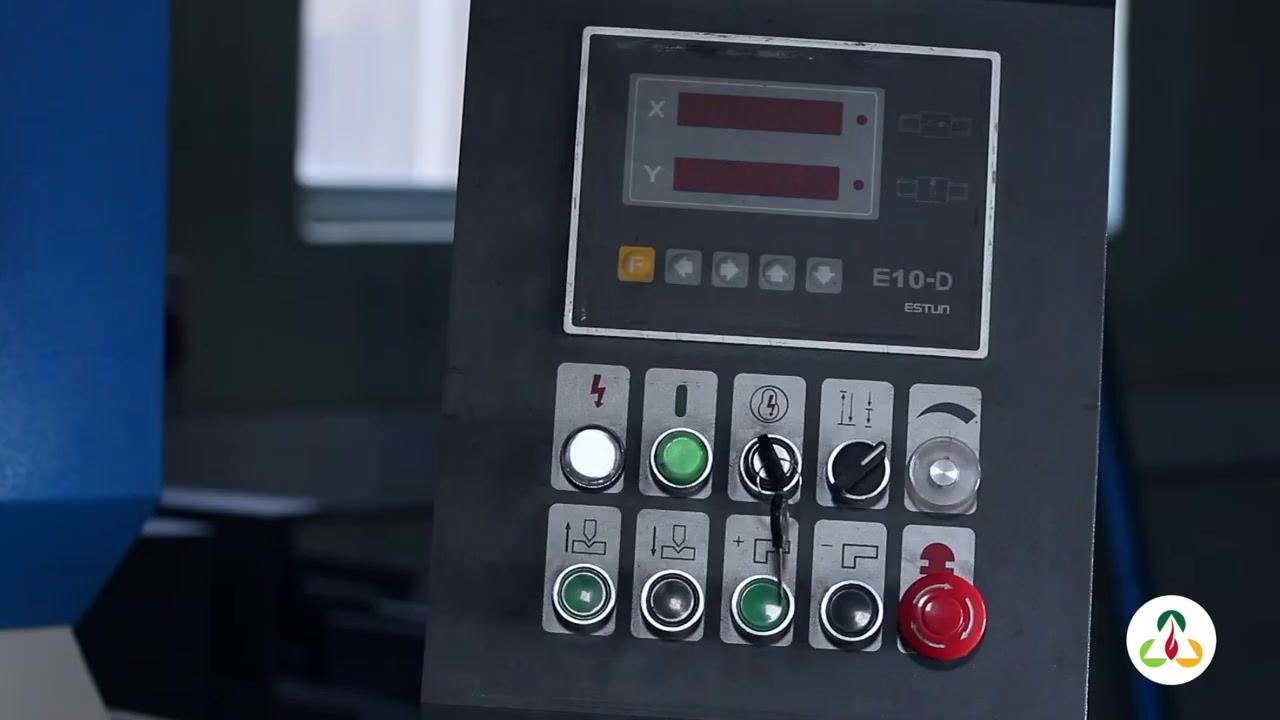 Close-up of gloved hands holding the metal plate and aligning the paper template to check the radius