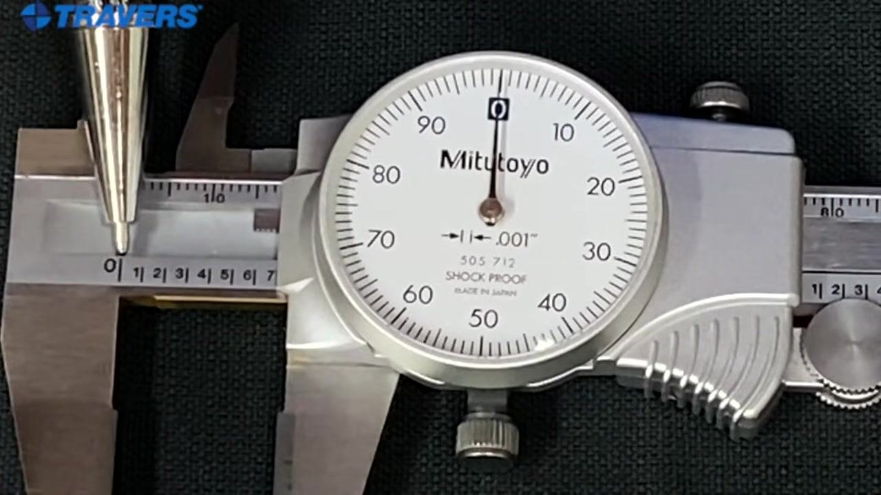 The caliper's edge aligned near the zero mark on the main scale, showing a measurement under one inch.