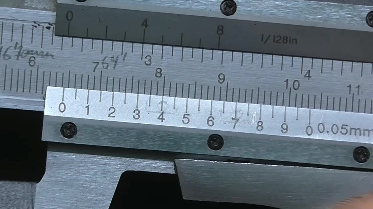 Vernier caliper positioned just past the 64 mm mark on the main scale, ready for the next reading.