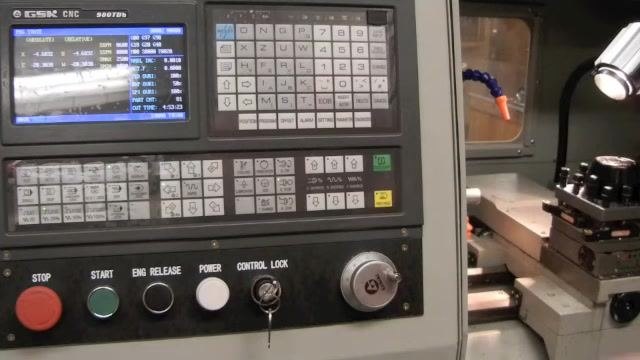 CNC controller and lathe setup ready for the facing operation, with the tool post positioned near the workpiece and the controller display visible.