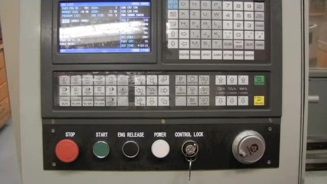 CNC controller panel displaying the program list window, with the PROGRAM button and other labeled controls visible.