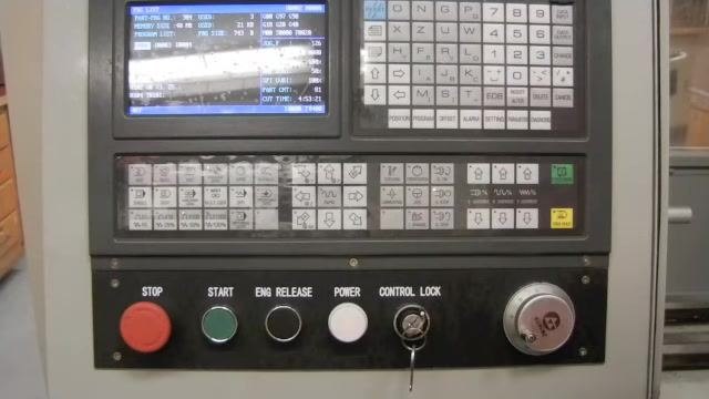 CNC controller panel with file O0002 highlighted in the program list.