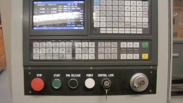 CNC controller panel with the display active and ready for manual tool carriage movement.