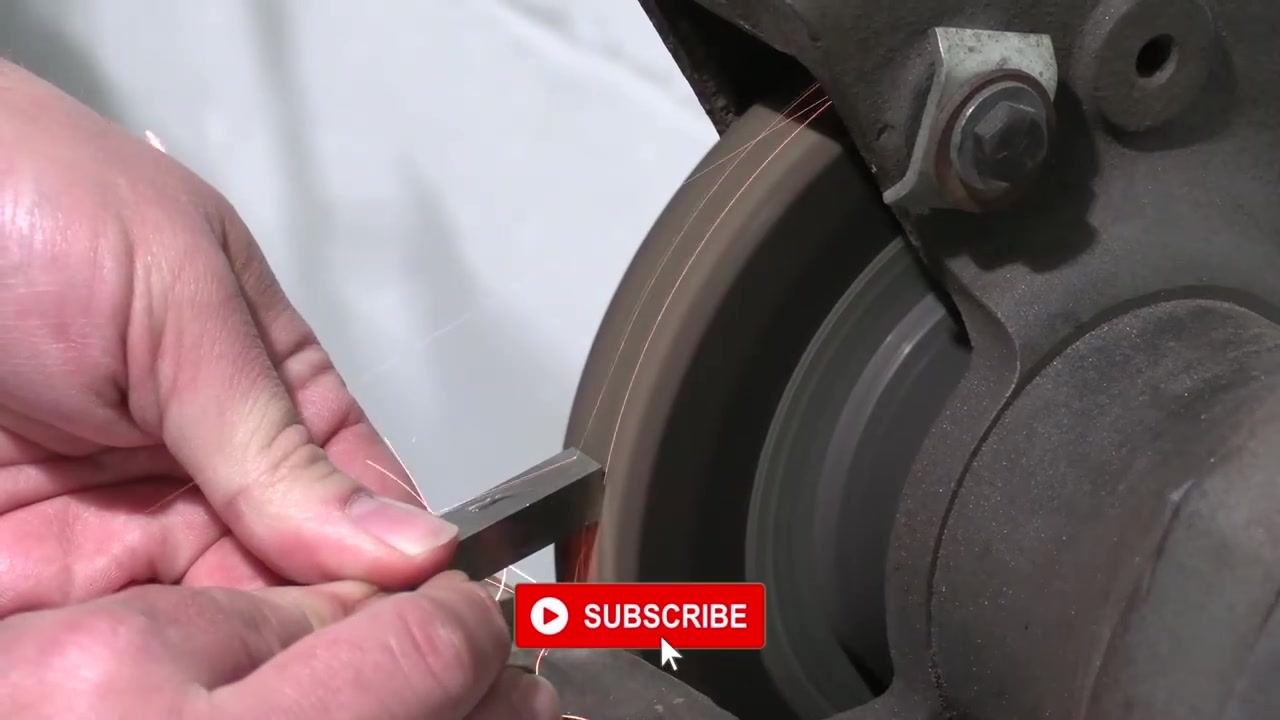 The tool bit is positioned against the grinding wheel to begin grinding the front clearance.