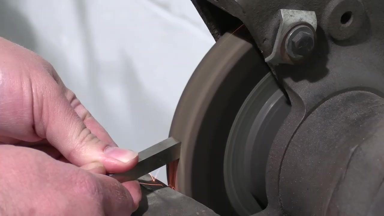 A close-up shows the tool bit held flat against the spinning grinding wheel, with sparks at the contact point, avoiding a curved grind.