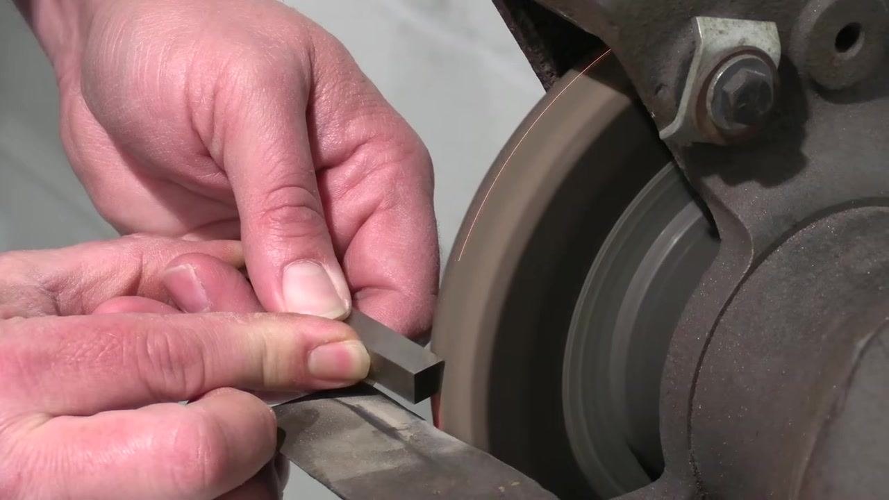 A final light grinding pass is made on the tool bit to complete the side clearance.