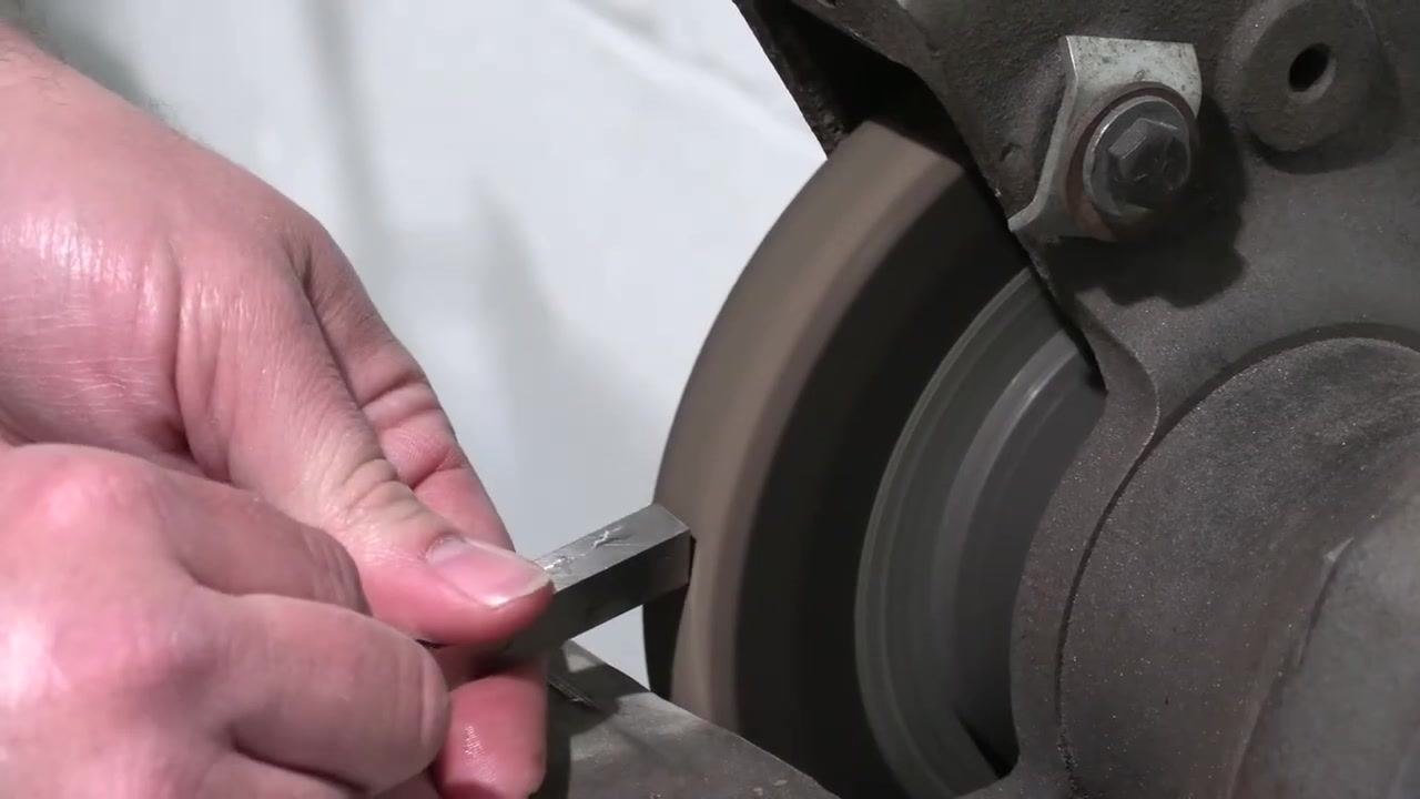 The tool bit is inspected closely to identify the area to be cleaned up for the front clearance.