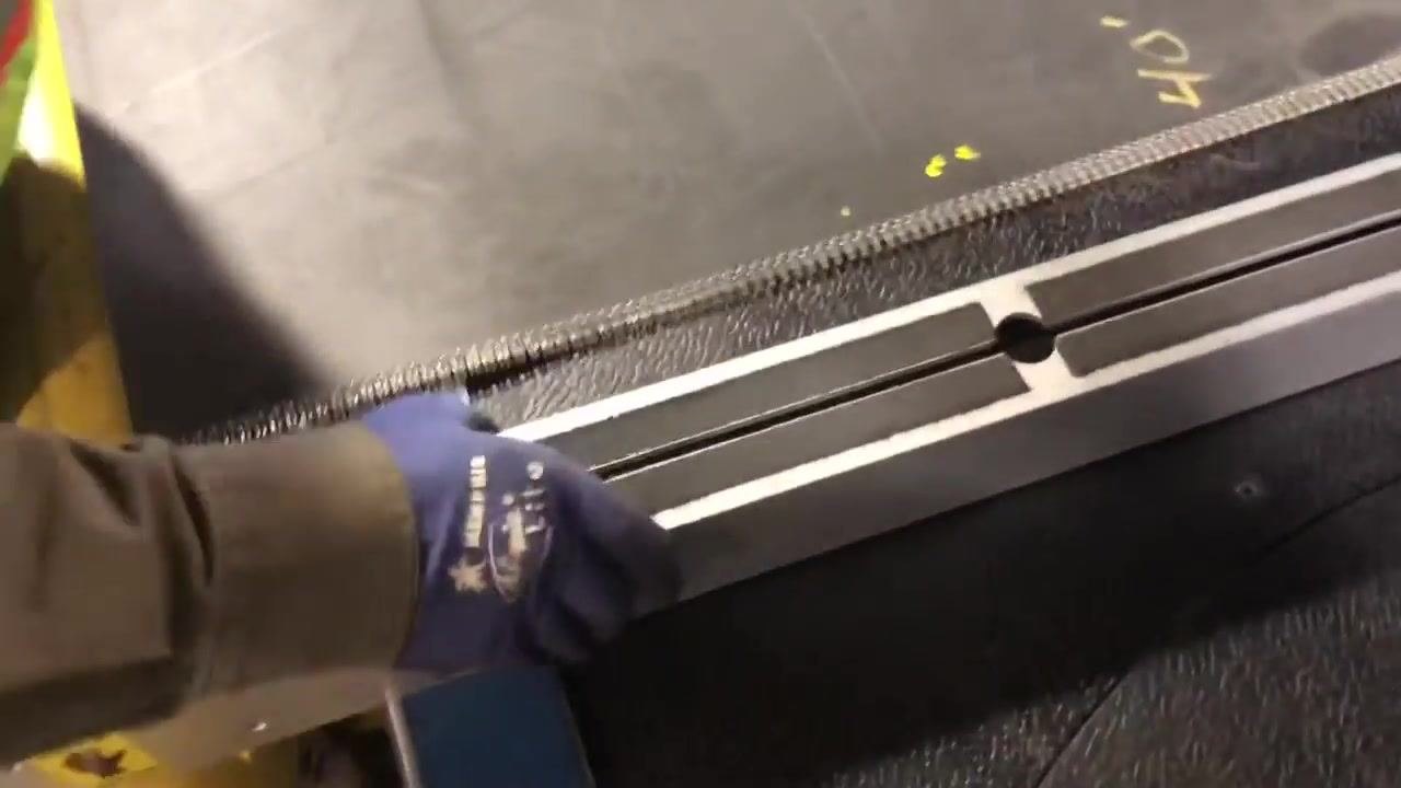 Close-up of the belt cutter handle and locking mechanism, with caution labels visible.