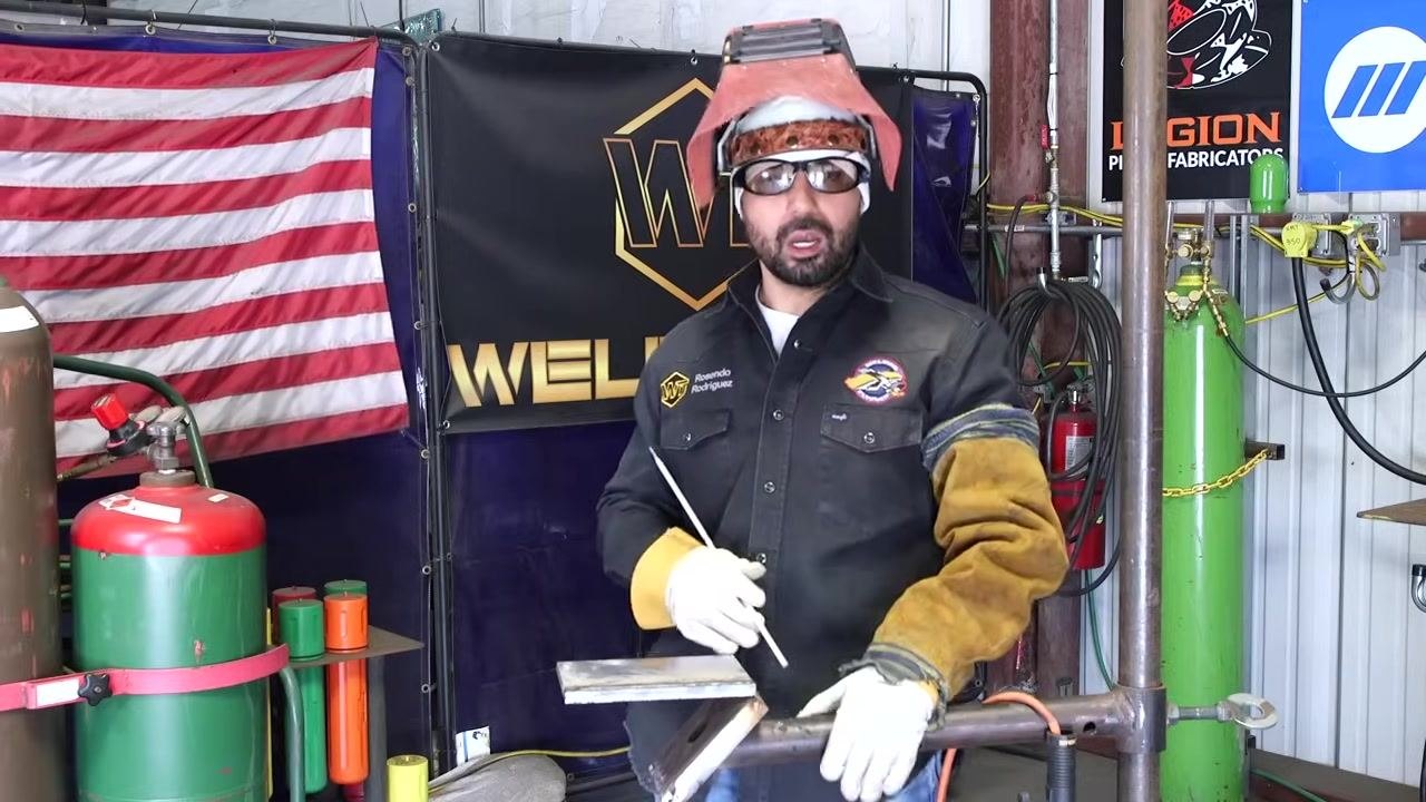 A welding rod is placed in the middle of a weld bead on a metal plate, illustrating a common but not always correct technique.