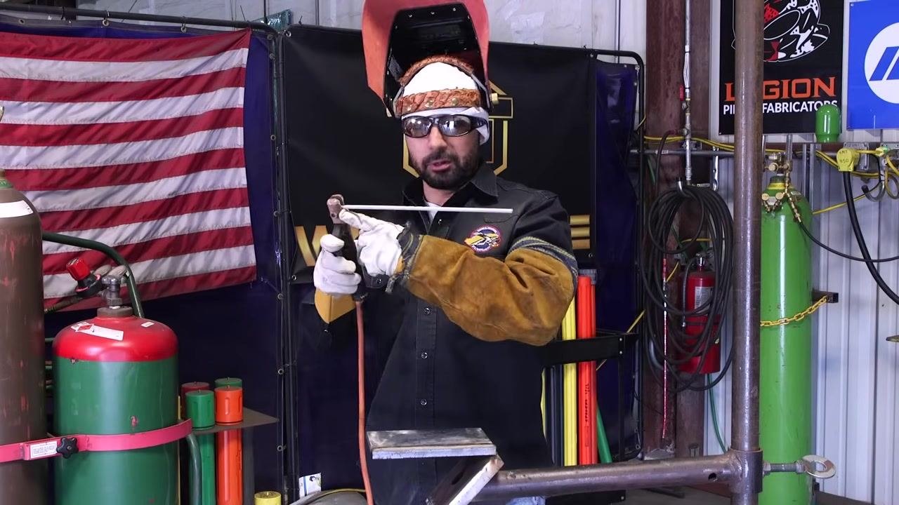 A welding rod placed in the groove of the workpiece demonstrates proper fit-up.
