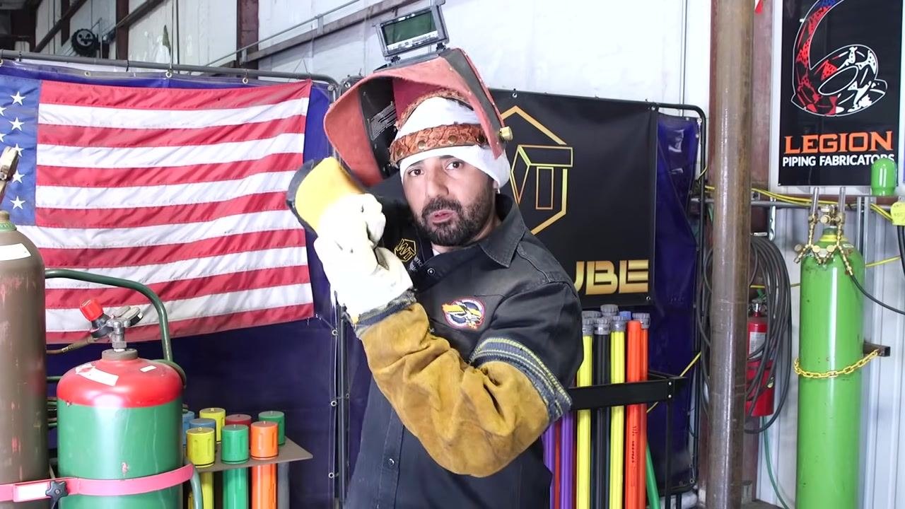Instructor demonstrating angle adjustment for better visibility, holding up gloved hand.
