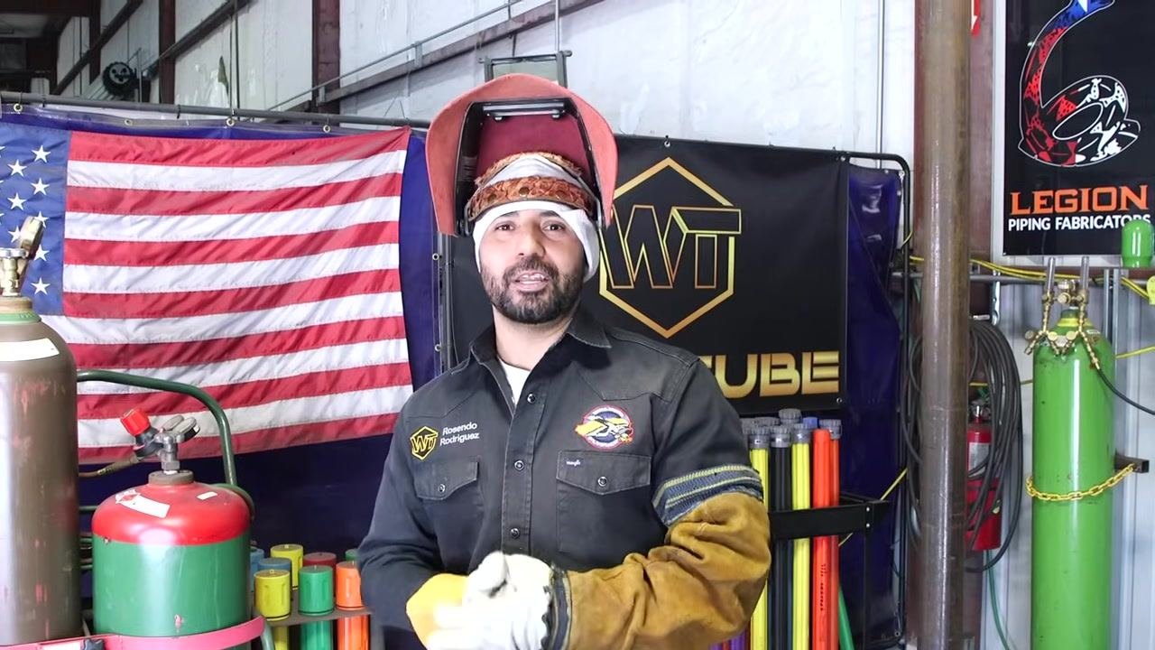 Instructor facing the camera, thanking the audience, helmet raised, hands together. Professional and positive closing.