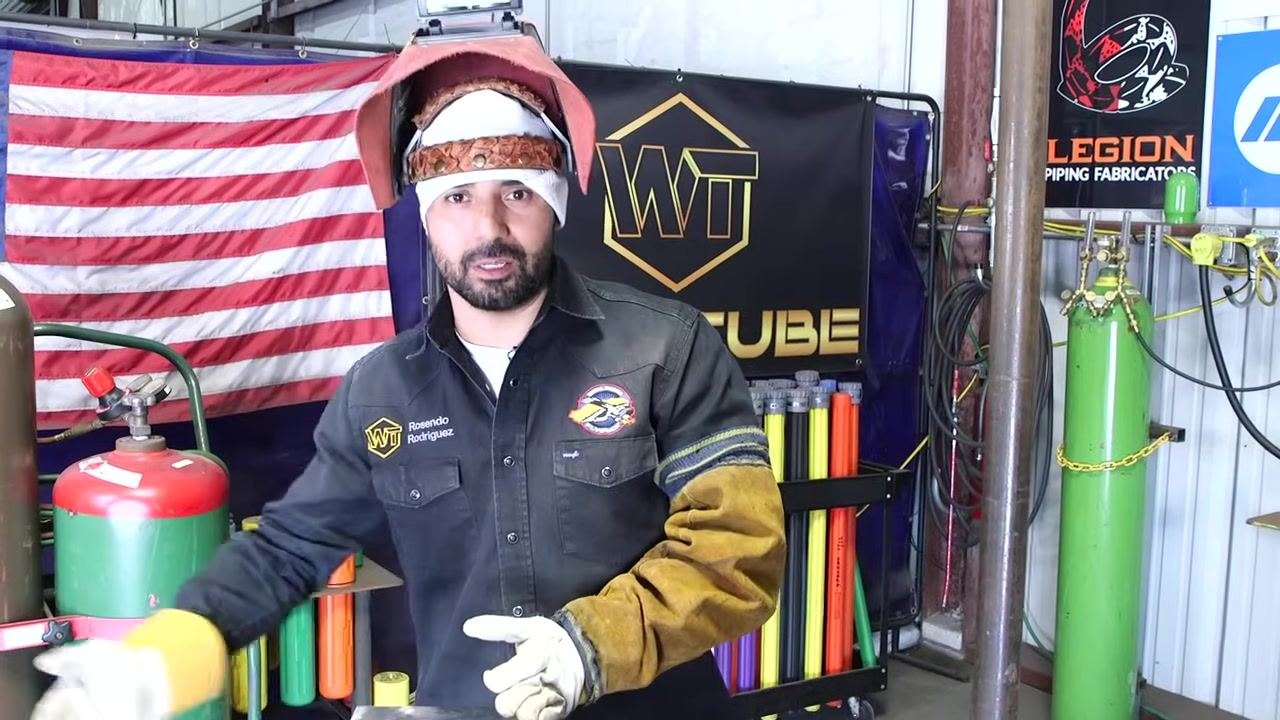 Instructor with helmet lifted, addressing the camera. Emphasis on visibility and safety. WT branding and American flag in background.