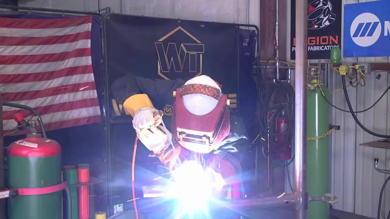 A close-up of the rod and puddle emphasizes steady movement and control during the weld.