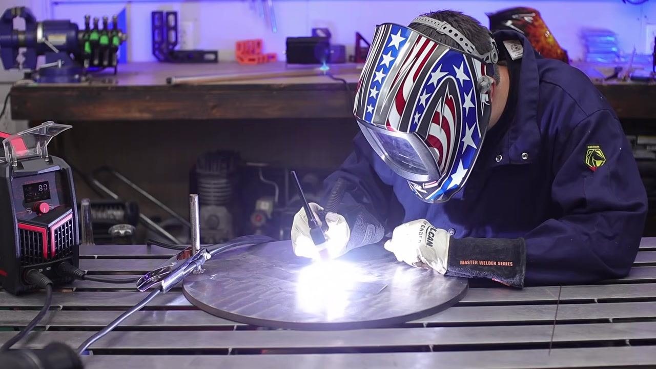 Welder continuing to weld with the arc visible, no filler rod added, focused on technique.