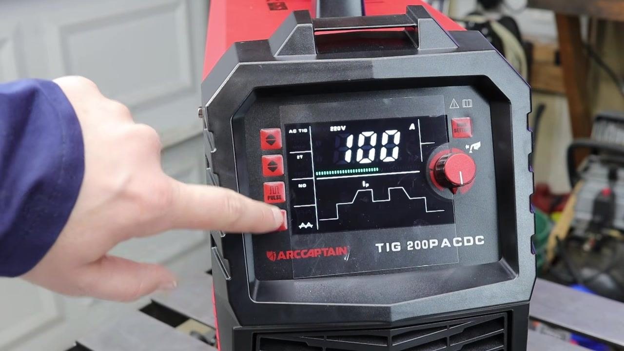 Hand pointing to the ARCCAPTAIN TIG 200P ACDC control panel, indicating adjustable settings such as pre-flow, post-flow, and pulse mode, with the display showing 100A.