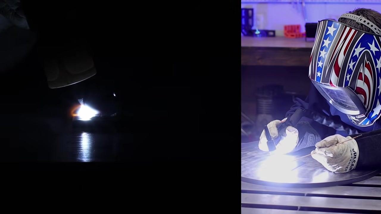 Split-screen view: a close-up of the arc and torch movement on the left, and the welder practicing technique wearing a patriotic-themed welding helmet and gloves on the right.
