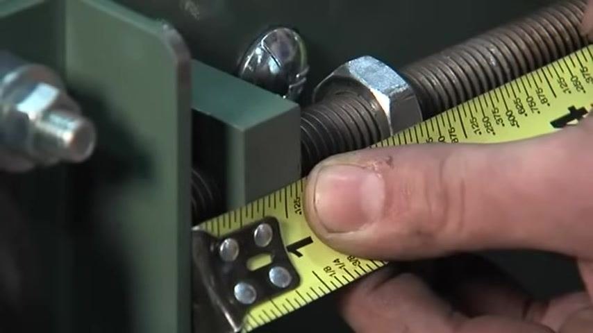 Tape measure confirming the tension screw is set to 1/2 inch