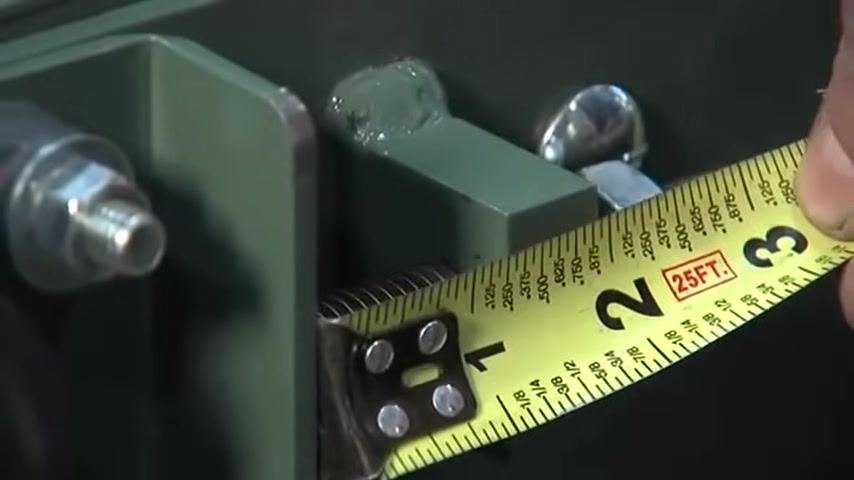 Measuring the tension screw adjustment at just over 1-1/2 inches