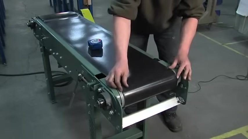 Checking belt tension by hand with the tape measure resting on the belt