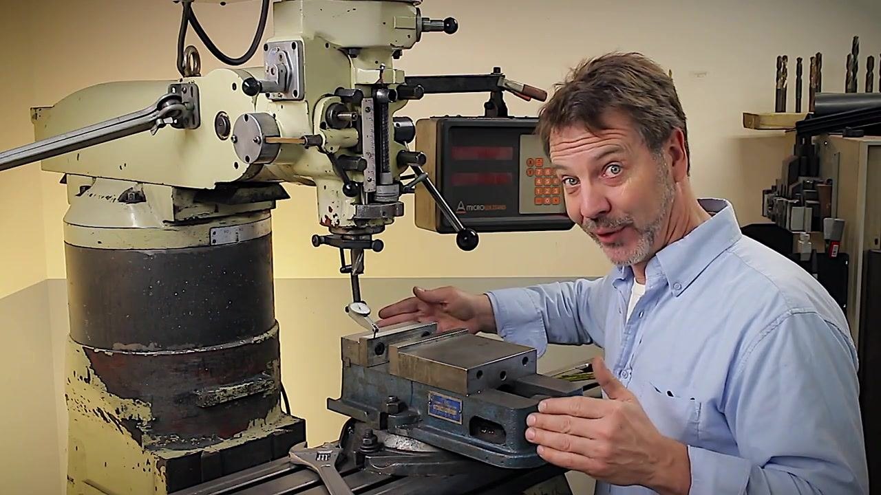The machinist enthusiastically encourages viewers to subscribe and engage with the channel, demonstrating a friendly and informative teaching style. The milling machine and aligned vise remain in view.