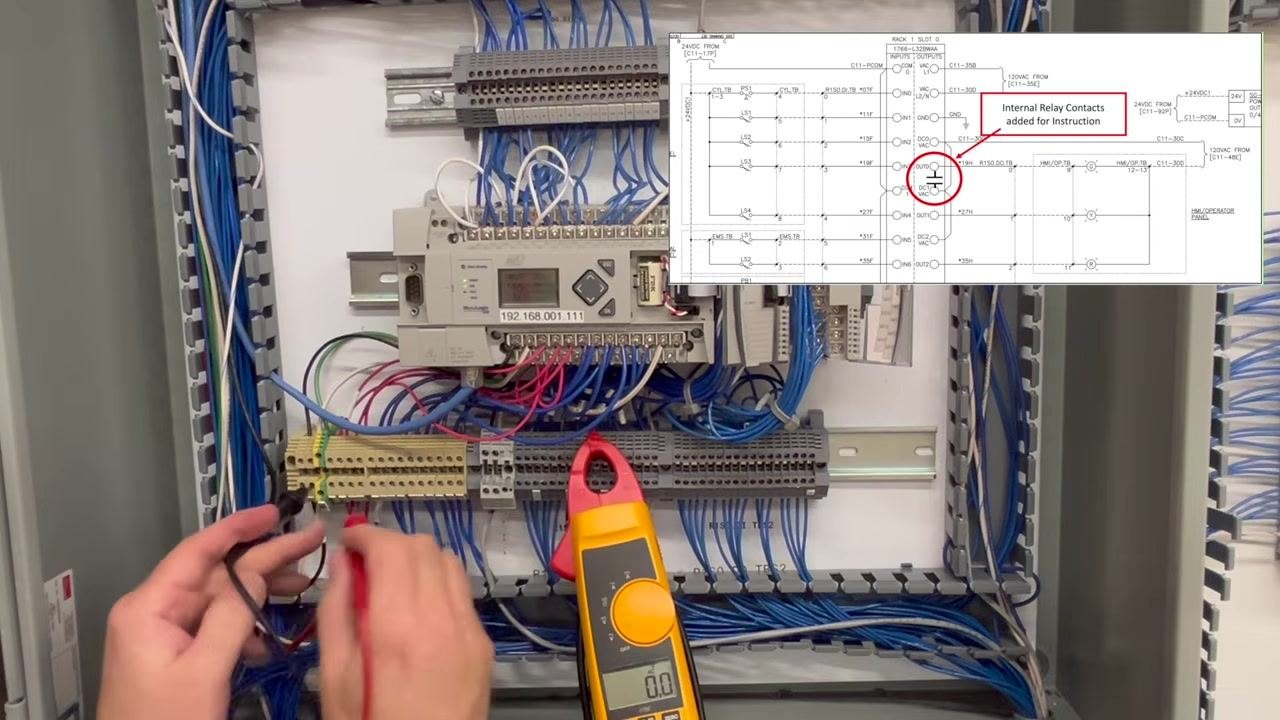 Both probes trace the power path, with the meter reading 0.0V and the schematic overlay visible.