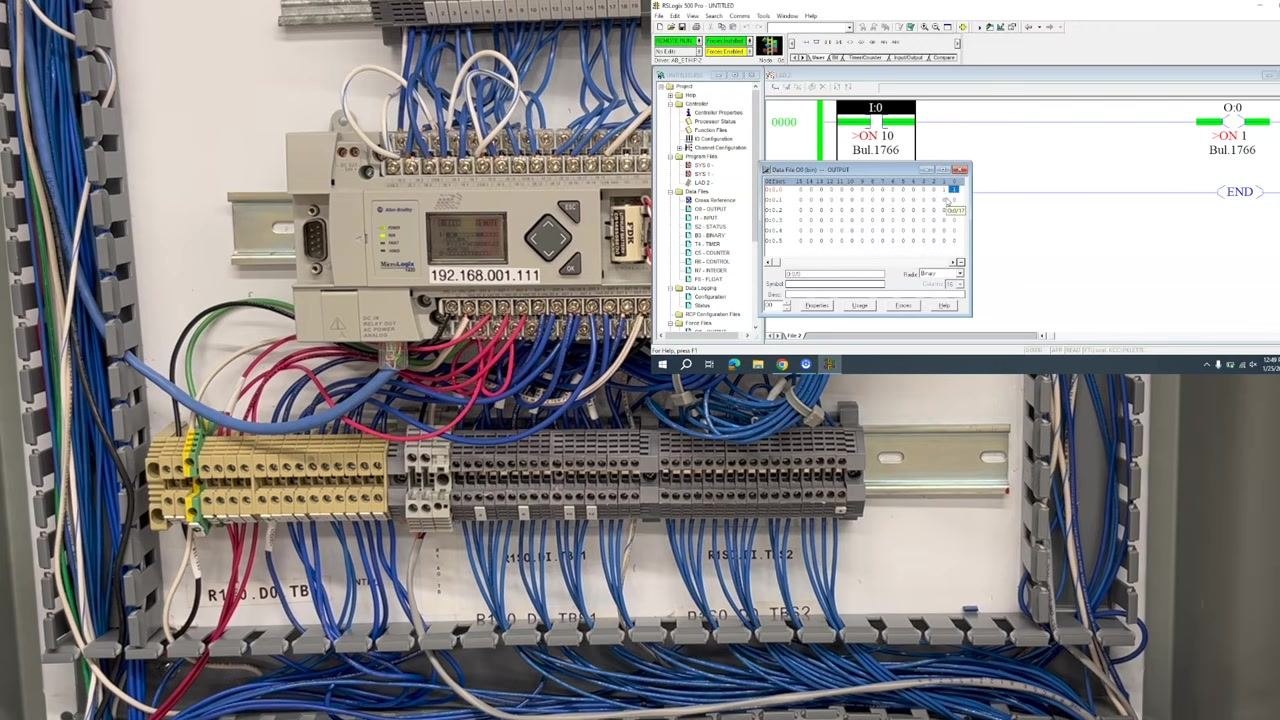 A view of the open control panel with wiring and simulator stations visible in a training lab environment.